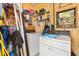 Functional laundry room with washer, dryer, and shelving for storage at 520 Saint Andrews Blvd, The Villages, FL 32159