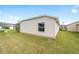 Exterior home with a well-manicured backyard, and visible vinyl siding at 5432 Todd Ct, The Villages, FL 32163