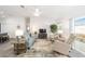 Bright living room featuring a ceiling fan, a comfortable sofa, stylish furniture, and a sliding glass door at 5432 Todd Ct, The Villages, FL 32163