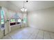 Bright dining room featuring large windows with sheer curtains and tile flooring at 600 Arlington Ct, Eustis, FL 32726