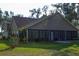 Spacious, screened in back porch area with a view of the backyard at 600 Urick St, Fruitland Park, FL 34731