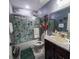 Bathroom featuring a shower-tub combo with sliding glass door, and modern vanity at 600 Urick St, Fruitland Park, FL 34731