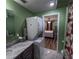 Convenient in-bathroom laundry area featuring a stacked washer and dryer and a modern vanity at 600 Urick St, Fruitland Park, FL 34731