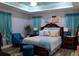 The primary bedroom showcases soft blue hues, tray ceilings, and a large, plush bed at 600 Urick St, Fruitland Park, FL 34731
