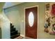 Inviting entryway with a decorative front door and adjacent staircase to the upper level of the home at 600 Urick St, Fruitland Park, FL 34731