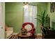 Comfortable living room area with a ceiling fan, a large window, a red chair and a cozy sofa at 600 Urick St, Fruitland Park, FL 34731