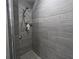 Inside of a tiled shower featuring sleek shower fixtures and neutral tones at 600 Urick St, Fruitland Park, FL 34731