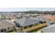 Aerial view of house showcasing roof, backyard patio, and landscaping at 6025 Dijulio Ter, The Villages, FL 32163