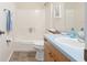 Bright bathroom with a tub and shower, with neutral tones and a light blue vanity countertop at 606 San Maria Street, Lady Lake, FL 32159