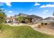 Beautiful backyard featuring a screened lanai and a well-maintained lawn with rock features at 6087 Manion Ter, The Villages, FL 32163