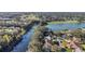 Scenic aerial view of homes nestled along a winding waterway and a large lake at 705 Cortez Ave, The Villages, FL 32159