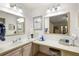 The main bathroom features double sinks, a makeup counter, and good lighting at 705 Cortez Ave, The Villages, FL 32159