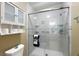 The bathroom features an updated glass door shower at 705 Cortez Ave, The Villages, FL 32159