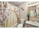 This cozy bathroom features a seashell-themed shower curtain and wall decor at 705 Cortez Ave, The Villages, FL 32159