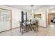 Bright dining room with glass-top table, stylish chairs, pendant lighting, and tiled flooring at 705 Cortez Ave, The Villages, FL 32159
