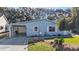 Charming home with light blue siding, a covered carport, and a beautifully landscaped front yard at 705 Cortez Ave, The Villages, FL 32159
