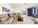 Inviting living room with comfortable seating, built-in shelving, and natural light at 705 Cortez Ave, The Villages, FL 32159
