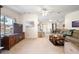 Comfortable living room features carpet floors, a ceiling fan, and breakfast bar at 705 Cortez Ave, The Villages, FL 32159
