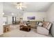 Open living room features a ceiling fan, carpeted floors, and a comfortable sectional couch at 705 Cortez Ave, The Villages, FL 32159