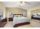 Spacious main bedroom with large bed, mirrored closet doors, and neutral paint at 705 Cortez Ave, The Villages, FL 32159