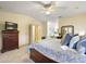 The main bedroom features a ceiling fan and an ensuite bathroom at 705 Cortez Ave, The Villages, FL 32159
