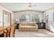 Bright sun room with tile flooring, a comfortable sofa, and multiple windows at 705 Cortez Ave, The Villages, FL 32159