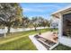 Backyard patio with water views, features a serene fountain and mature trees at 736 Heathrow Ave, The Villages, FL 32159