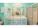 Bathroom featuring a double sink vanity, decorative mirror, and walk-in shower at 736 Heathrow Ave, The Villages, FL 32159