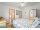 Cozy bedroom boasts a ceiling fan, complemented by natural light and en-suite bathroom access at 736 Heathrow Ave, The Villages, FL 32159