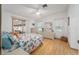 Bright bedroom featuring a sliding glass door, ceiling fan, and light wood laminate flooring at 736 Heathrow Ave, The Villages, FL 32159