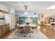 Bright dining area features a mural, stylish lighting, and a cozy rug under the dining table at 736 Heathrow Ave, The Villages, FL 32159