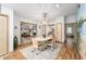 Bright dining area with a chandelier, adjacent to the living room, and abundant natural light at 736 Heathrow Ave, The Villages, FL 32159