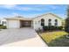 Charming single-story home featuring a well-maintained lawn and a spacious driveway at 736 Heathrow Ave, The Villages, FL 32159