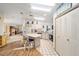 Bright kitchen featuring an island with seating, white cabinetry, and modern appliances at 736 Heathrow Ave, The Villages, FL 32159