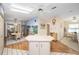 Spacious kitchen with an island, white cabinets, modern appliances, and an adjacent breakfast area at 736 Heathrow Ave, The Villages, FL 32159