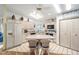 Bright kitchen featuring an island with seating, white appliances, and white cabinetry at 736 Heathrow Ave, The Villages, FL 32159