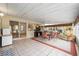 Large lanai with dining area, desk and TV offers a flexible entertainment space at 736 Heathrow Ave, The Villages, FL 32159