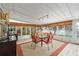 Spacious lanai features lake view, with a ceiling fan and dining area at 736 Heathrow Ave, The Villages, FL 32159