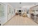 Bright living room features fireplace, tile floors, and access to the lanai with views at 736 Heathrow Ave, The Villages, FL 32159