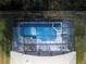 Top-down view of a screened pool and spa with surrounding patio and backyard at 8161 Sun Palm Dr, Kissimmee, FL 34747