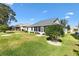 Backyard view with a well-manicured lawn and landscape at 8294 Se 177Th Winterthur Loop, The Villages, FL 32162