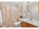 Bright bathroom with a shower, patterned shower curtain, and decorative beach themed wall art at 8294 Se 177Th Winterthur Loop, The Villages, FL 32162