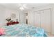 Bedroom view featuring a ceiling fan, a mirror, and a closet at 8294 Se 177Th Winterthur Loop, The Villages, FL 32162