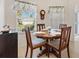 Bright dining area features a round table, wood chairs, and natural light from a large window at 8294 Se 177Th Winterthur Loop, The Villages, FL 32162