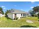 The exterior of the property shows a well-maintained yard and a screened-in porch, perfect for enjoying the outdoors at 8294 Se 177Th Winterthur Loop, The Villages, FL 32162