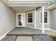 Covered front porch featuring a secure front door and exterior siding that enhances the entrance to the home at 8294 Se 177Th Winterthur Loop, The Villages, FL 32162