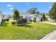 Well-manicured lawn and landscaping surround this single-story home with a two-car garage and concrete driveway at 8294 Se 177Th Winterthur Loop, The Villages, FL 32162