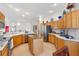 Bright kitchen featuring light wood cabinets, granite countertops, stainless steel appliances, and an island at 8294 Se 177Th Winterthur Loop, The Villages, FL 32162