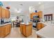 Bright kitchen featuring light wood cabinets, granite countertops, stainless steel appliances, and a cozy breakfast nook at 8294 Se 177Th Winterthur Loop, The Villages, FL 32162