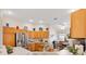 Bright kitchen featuring light wood cabinets, granite countertops, stainless steel appliances, and a cozy breakfast nook at 8294 Se 177Th Winterthur Loop, The Villages, FL 32162